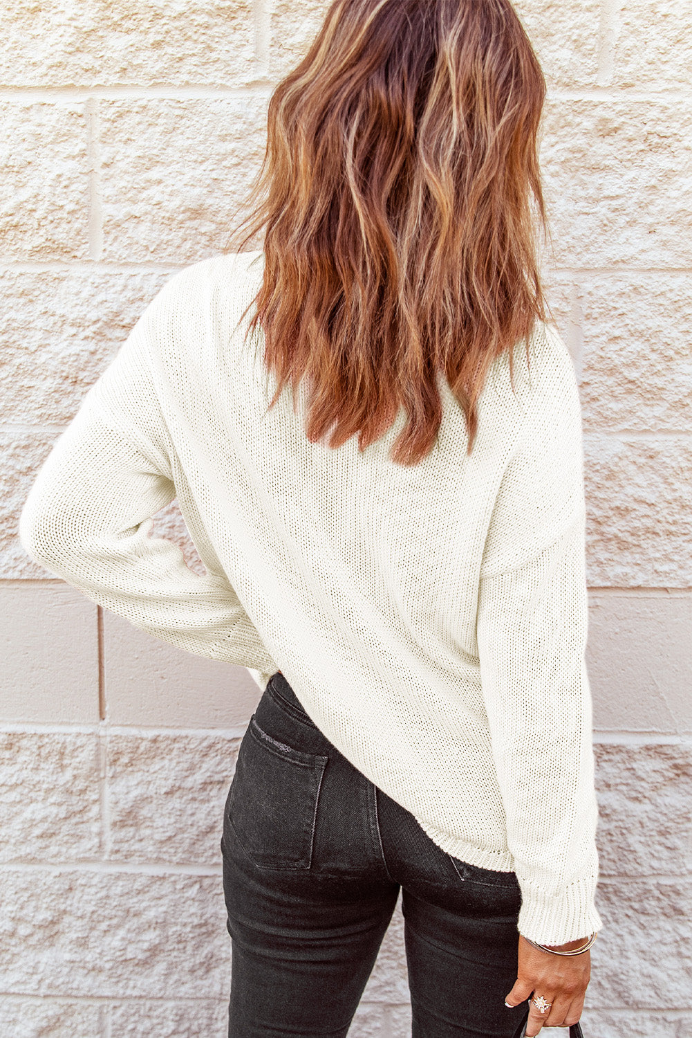 A stylish pink oversize knitted sweater with drop-shoulder sleeves, perfect for winter wear.