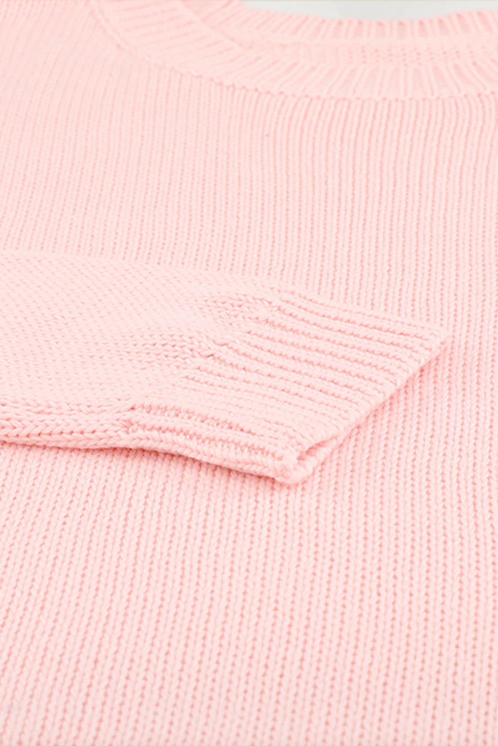 A stylish pink oversize knitted sweater with drop-shoulder sleeves, perfect for winter wear.