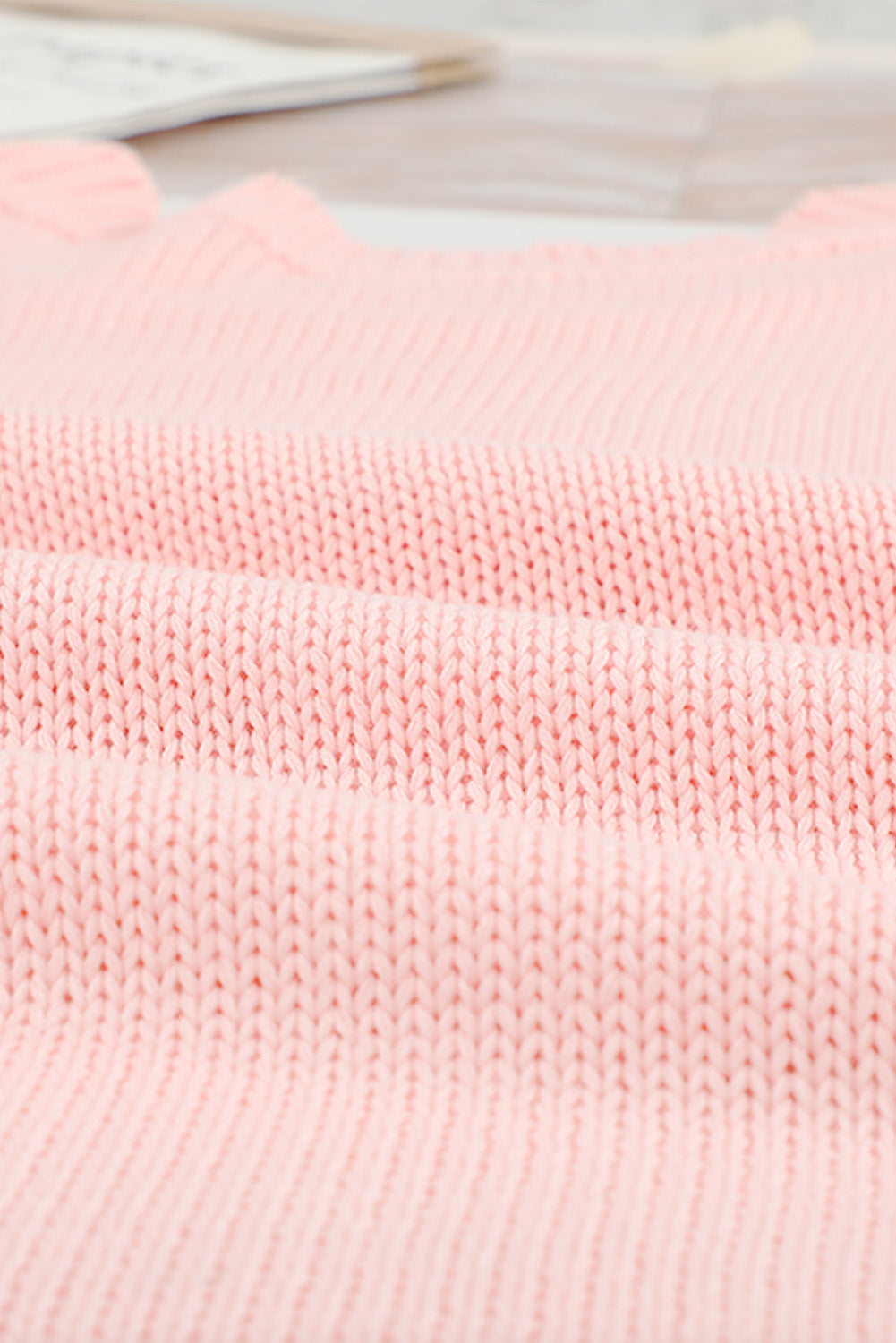 A stylish pink oversize knitted sweater with drop-shoulder sleeves, perfect for winter wear.