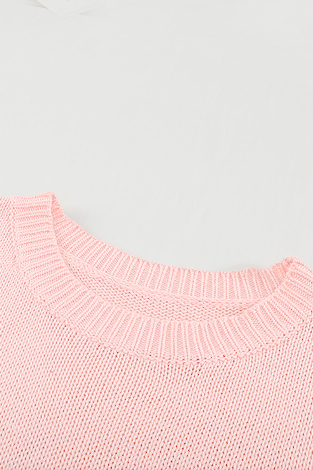 A stylish pink oversize knitted sweater with drop-shoulder sleeves, perfect for winter wear.