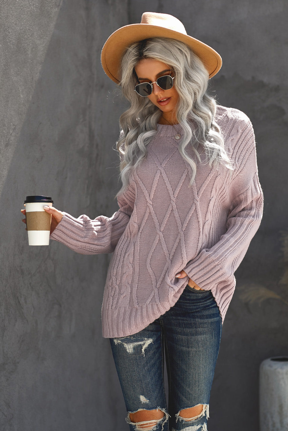 A cozy pink oversize thick pullover sweater with a cable knit design, perfect for winter wear.