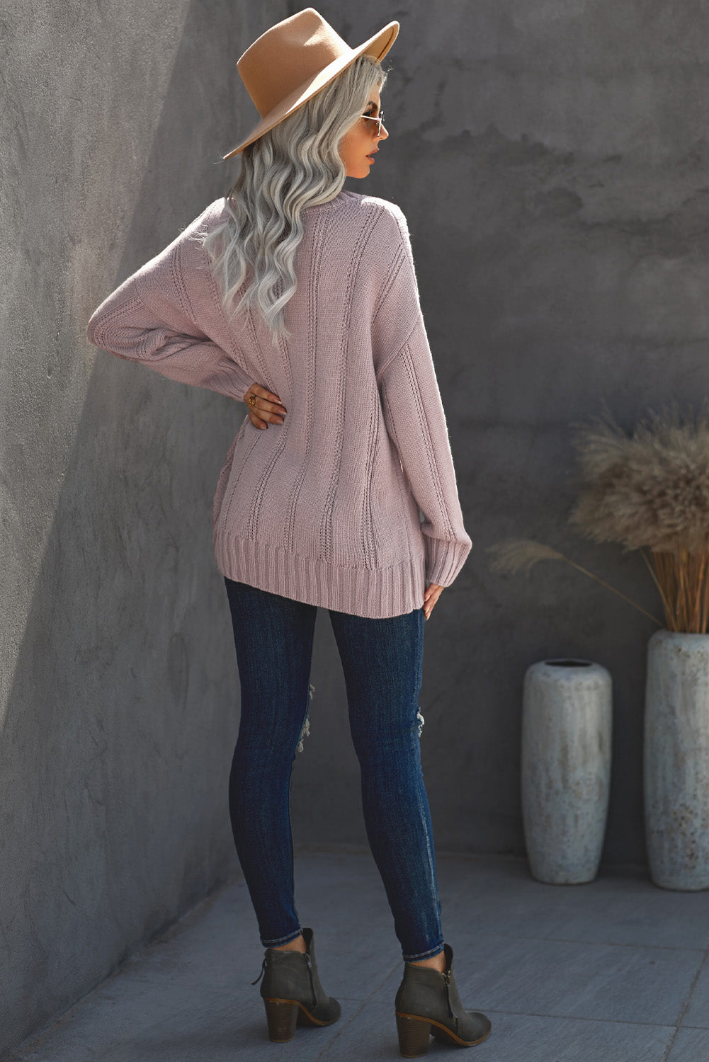 A cozy pink oversize thick pullover sweater with a cable knit design, perfect for winter wear.