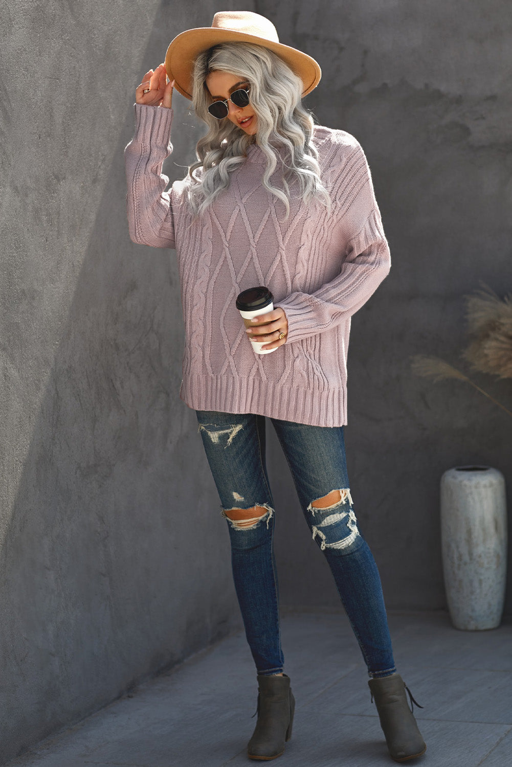 A cozy pink oversize thick pullover sweater with a cable knit design, perfect for winter wear.