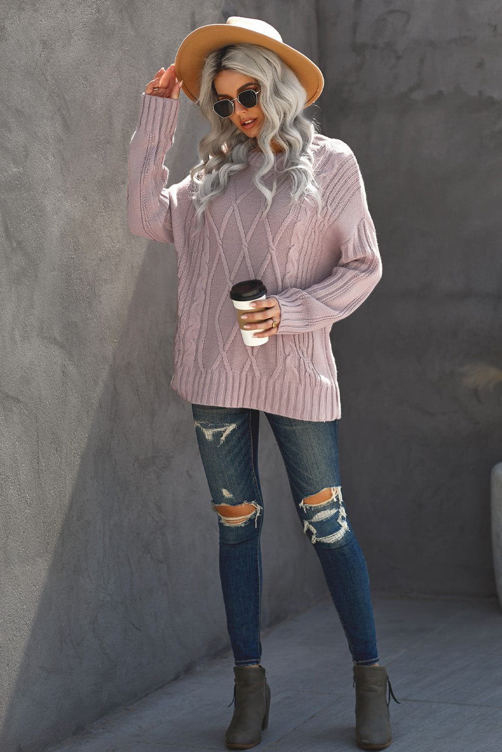 A cozy pink oversize thick pullover sweater with a cable knit design, perfect for winter wear.