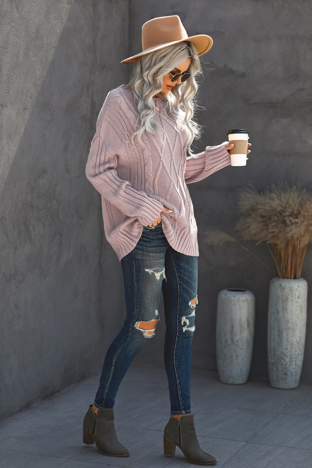 A cozy pink oversize thick pullover sweater with a cable knit design, perfect for winter wear.