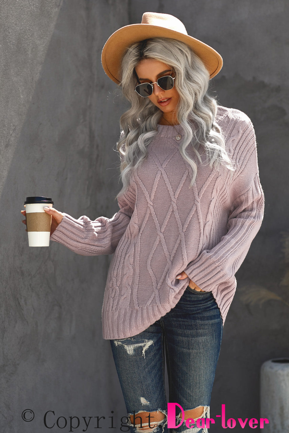 A cozy pink oversize thick pullover sweater with a cable knit design, perfect for winter wear.