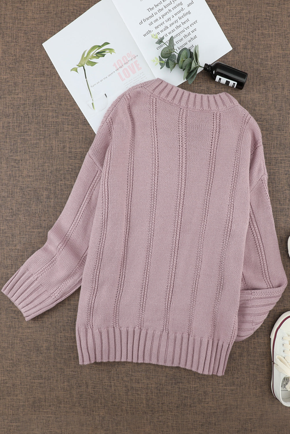 A cozy pink oversize thick pullover sweater with a cable knit design, perfect for winter wear.