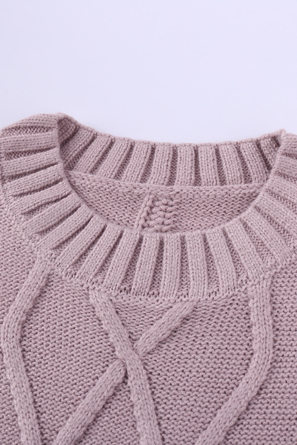 A cozy pink oversize thick pullover sweater with a cable knit design, perfect for winter wear.