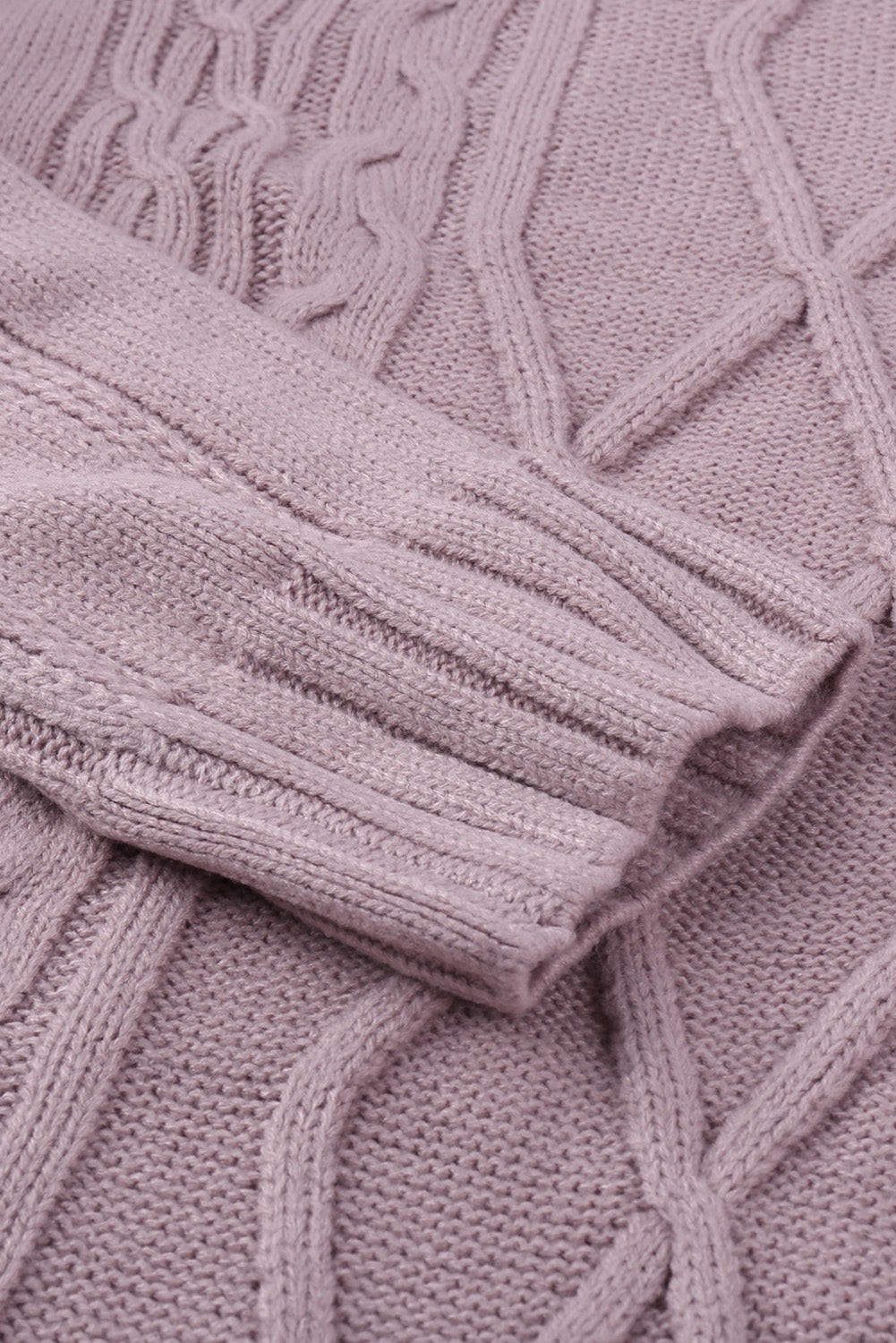 A cozy pink oversize thick pullover sweater with a cable knit design, perfect for winter wear.