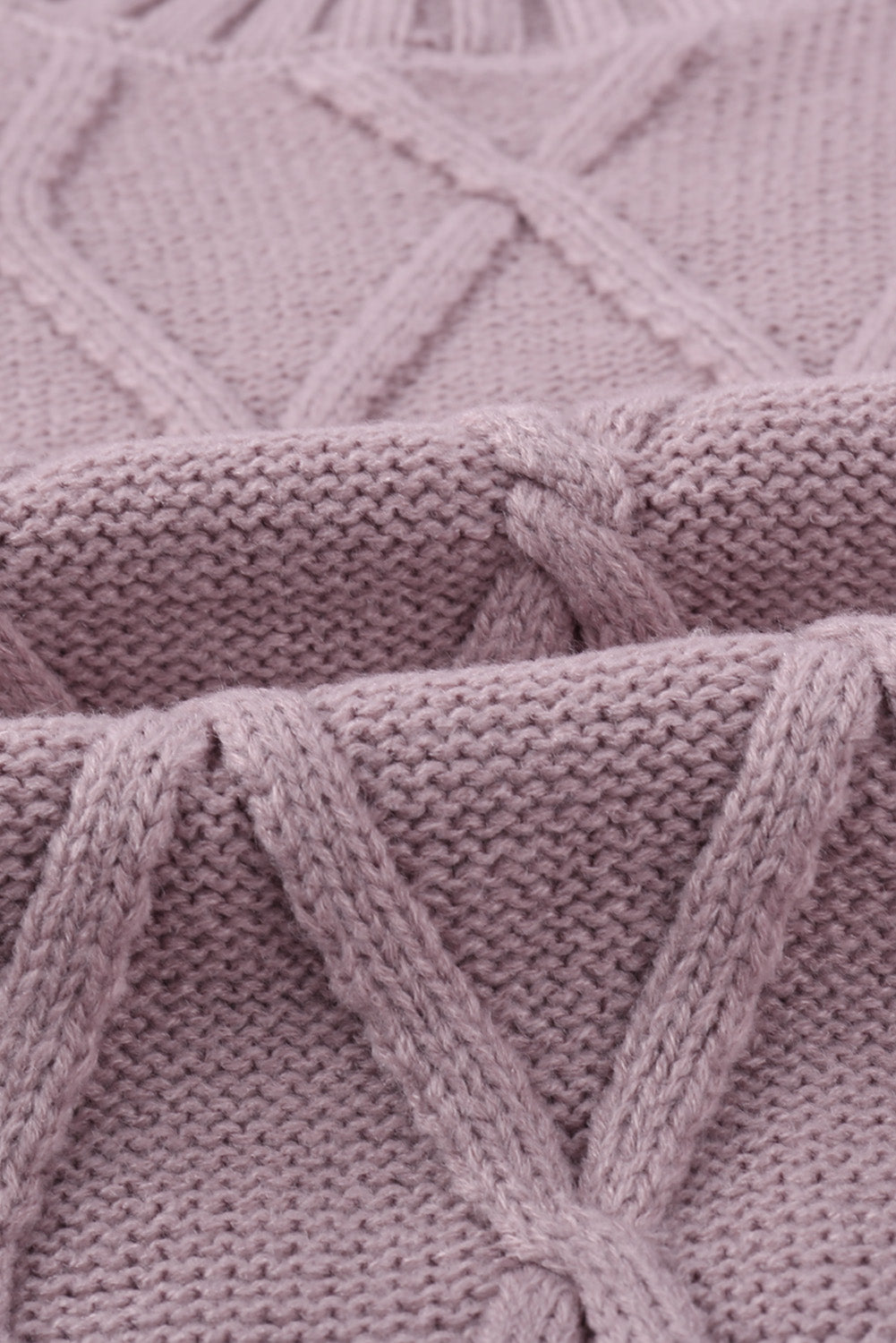 A cozy pink oversize thick pullover sweater with a cable knit design, perfect for winter wear.