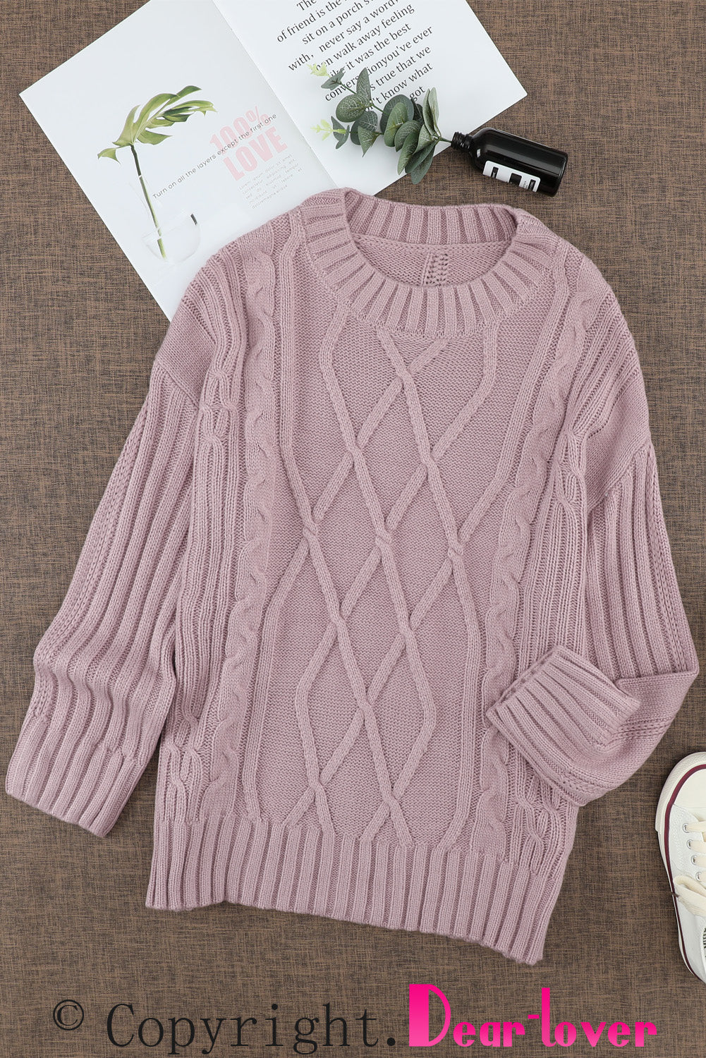 A cozy pink oversize thick pullover sweater with a cable knit design, perfect for winter wear.