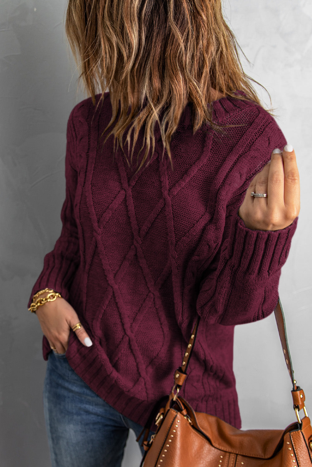 A cozy pink oversize thick pullover sweater with a cable knit design, perfect for winter wear.