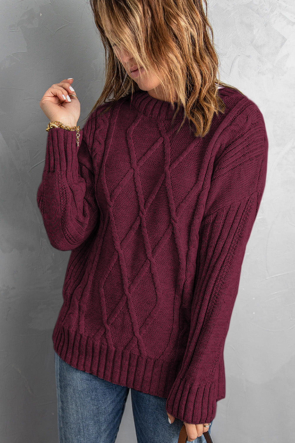 A cozy pink oversize thick pullover sweater with a cable knit design, perfect for winter wear.