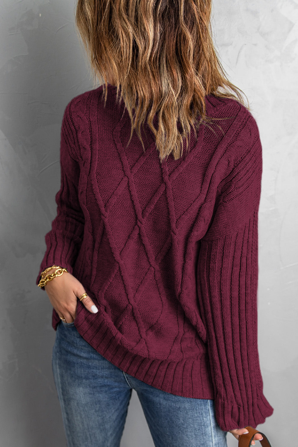 A cozy pink oversize thick pullover sweater with a cable knit design, perfect for winter wear.