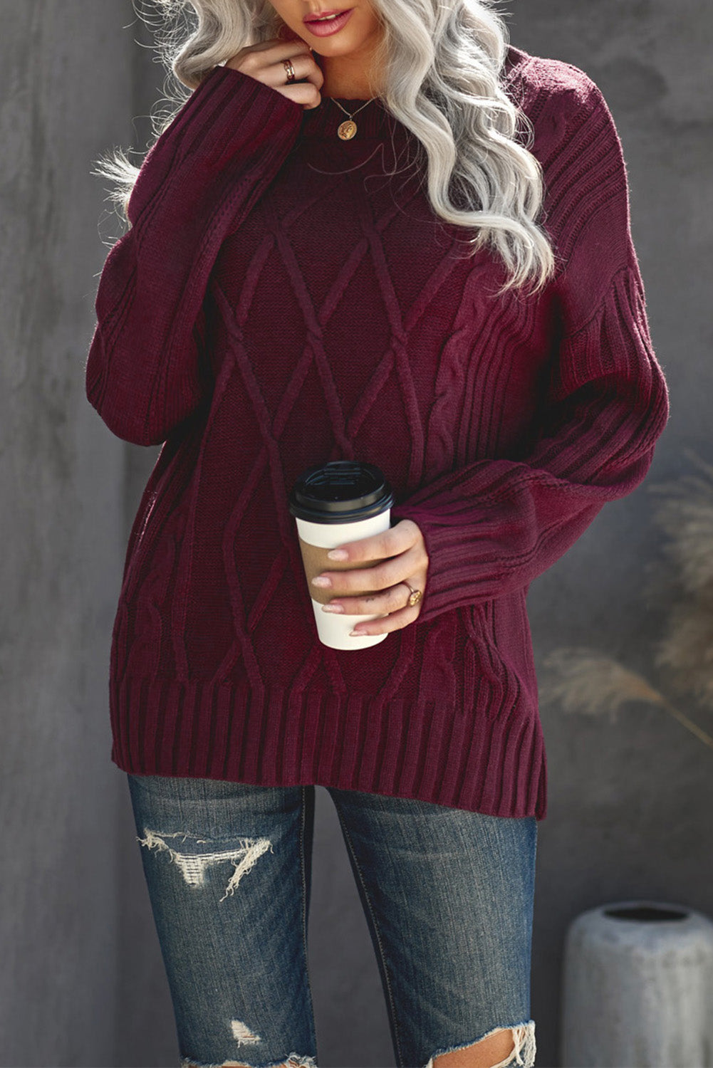 A cozy pink oversize thick pullover sweater with a cable knit design, perfect for winter wear.