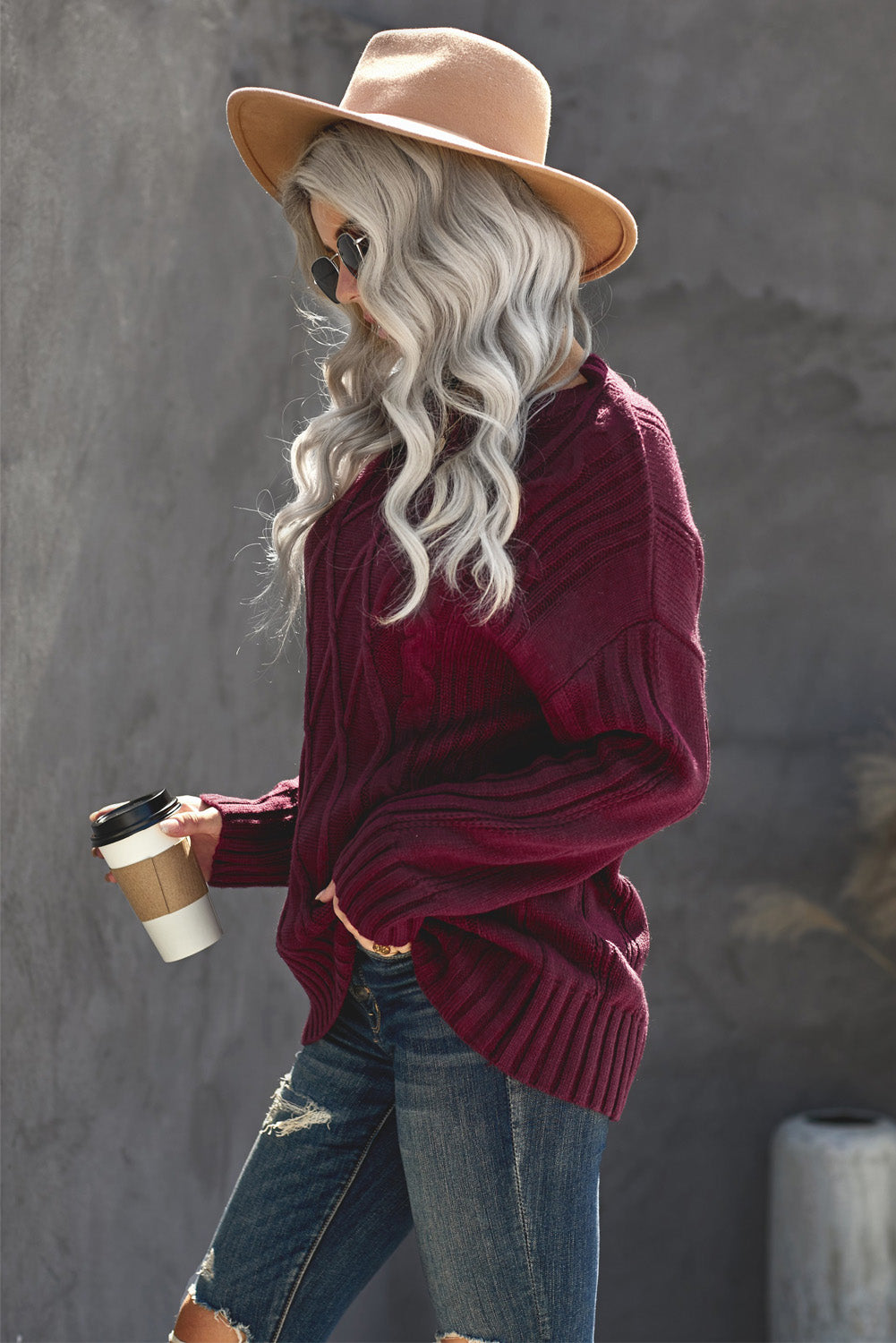 A cozy pink oversize thick pullover sweater with a cable knit design, perfect for winter wear.