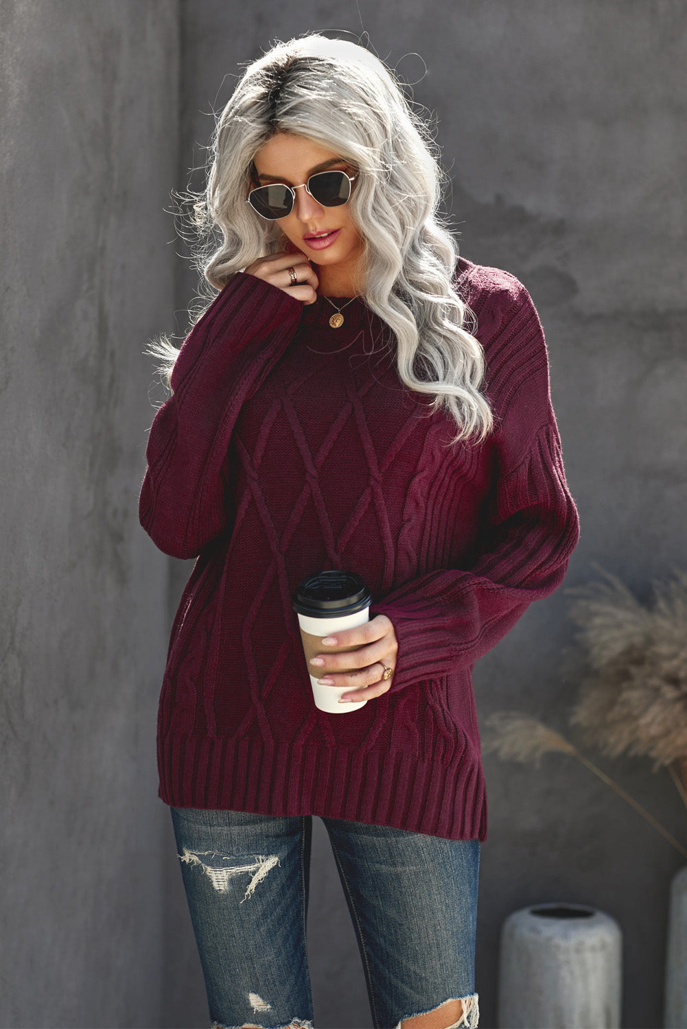 A cozy pink oversize thick pullover sweater with a cable knit design, perfect for winter wear.