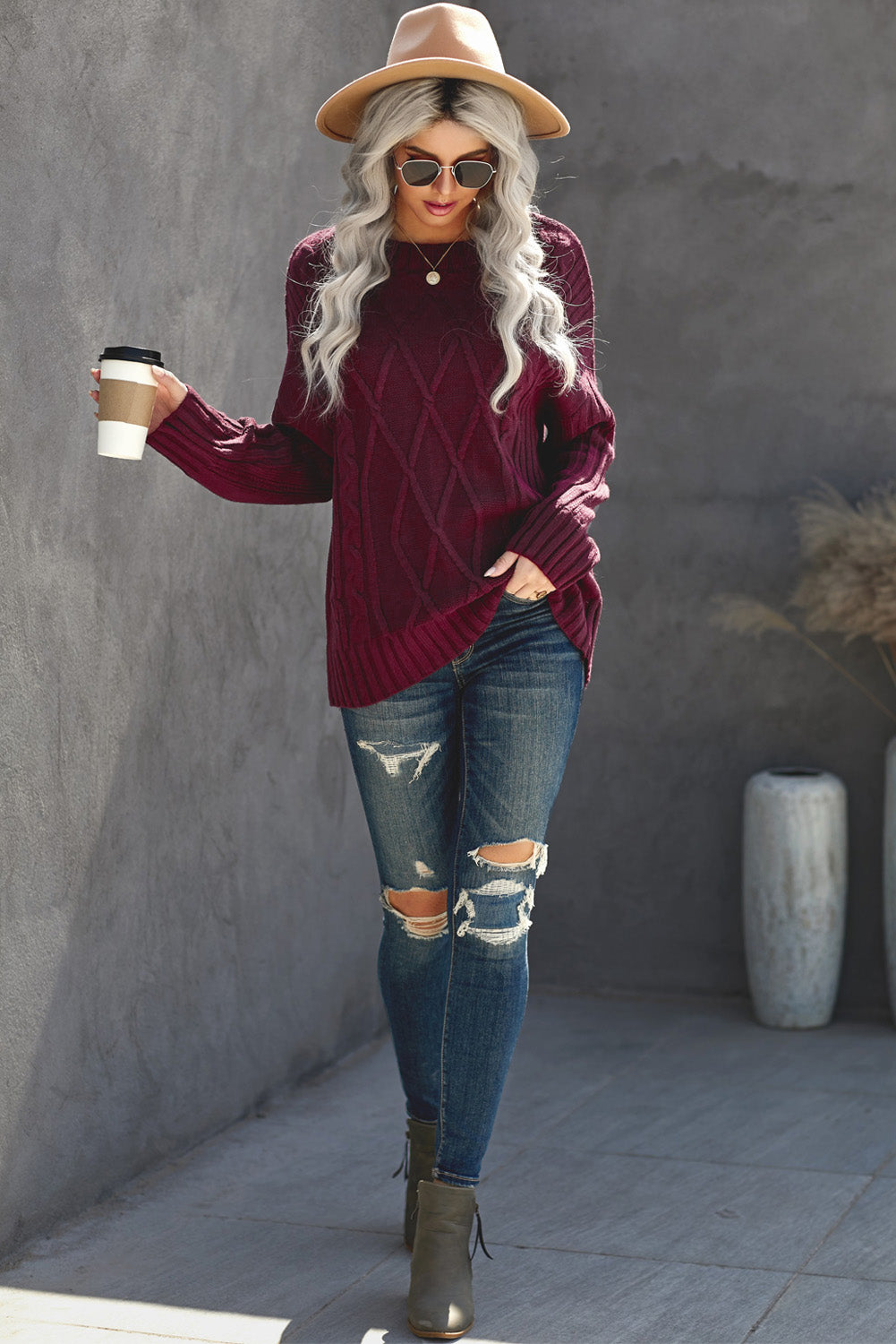 A cozy pink oversize thick pullover sweater with a cable knit design, perfect for winter wear.