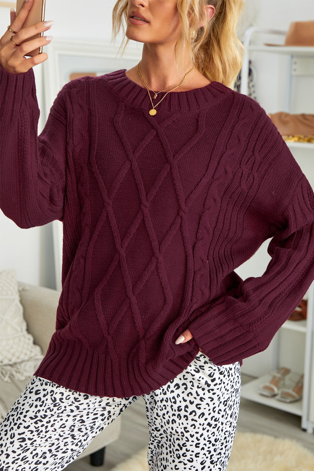 A cozy pink oversize thick pullover sweater with a cable knit design, perfect for winter wear.