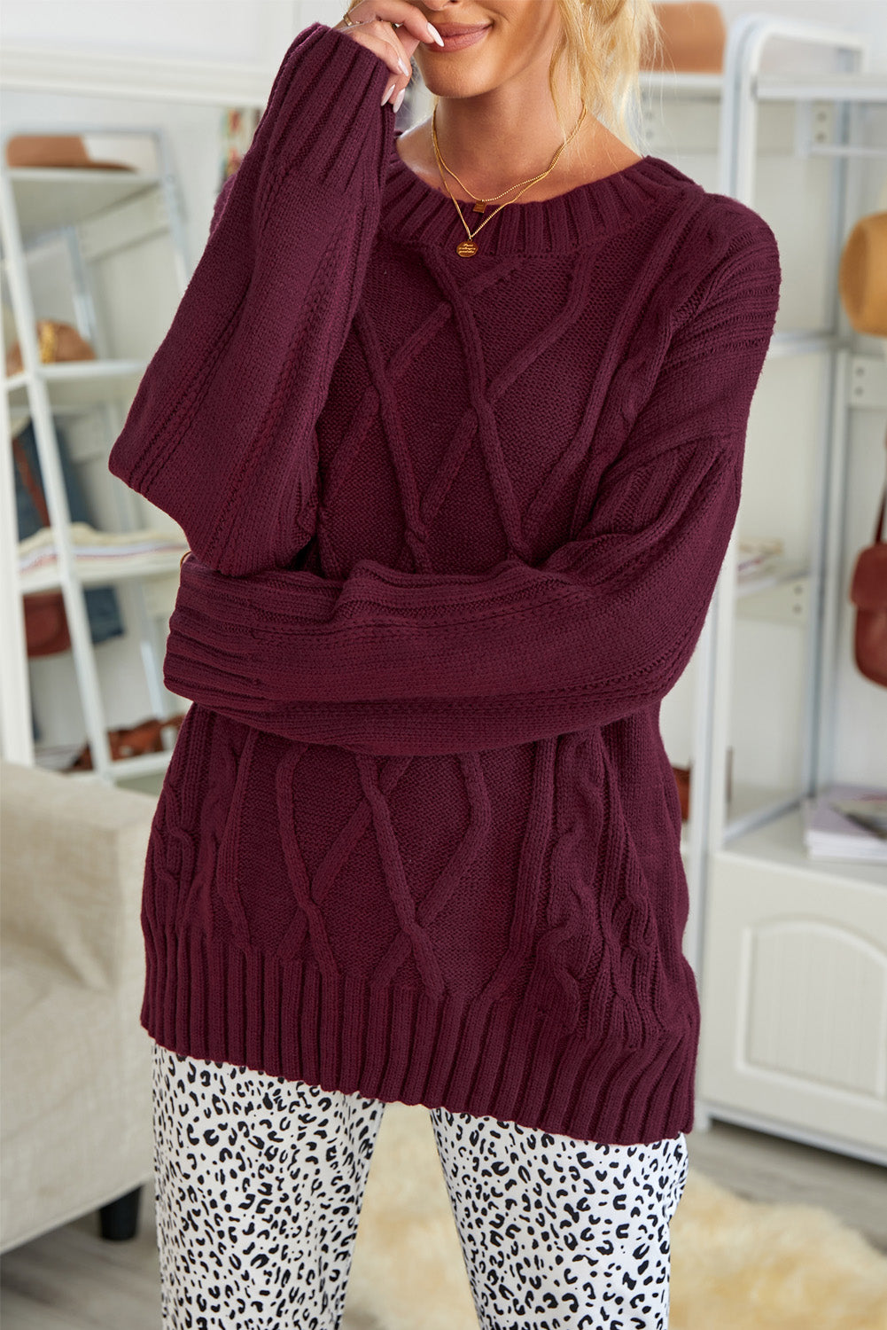 A cozy pink oversize thick pullover sweater with a cable knit design, perfect for winter wear.