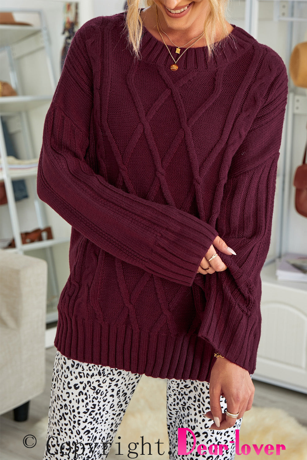 A cozy pink oversize thick pullover sweater with a cable knit design, perfect for winter wear.