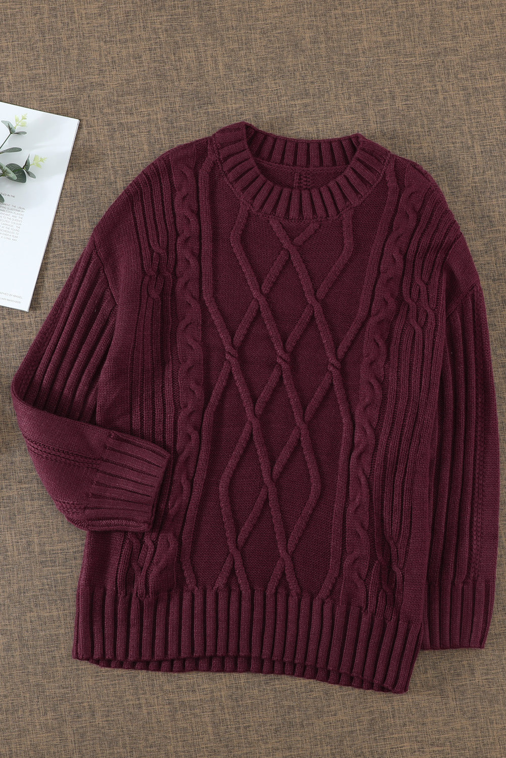 A cozy pink oversize thick pullover sweater with a cable knit design, perfect for winter wear.