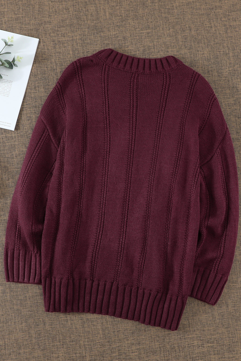 A cozy pink oversize thick pullover sweater with a cable knit design, perfect for winter wear.