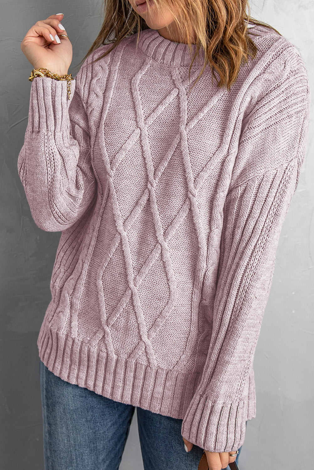 A cozy pink oversize thick pullover sweater with a cable knit design, perfect for winter wear.