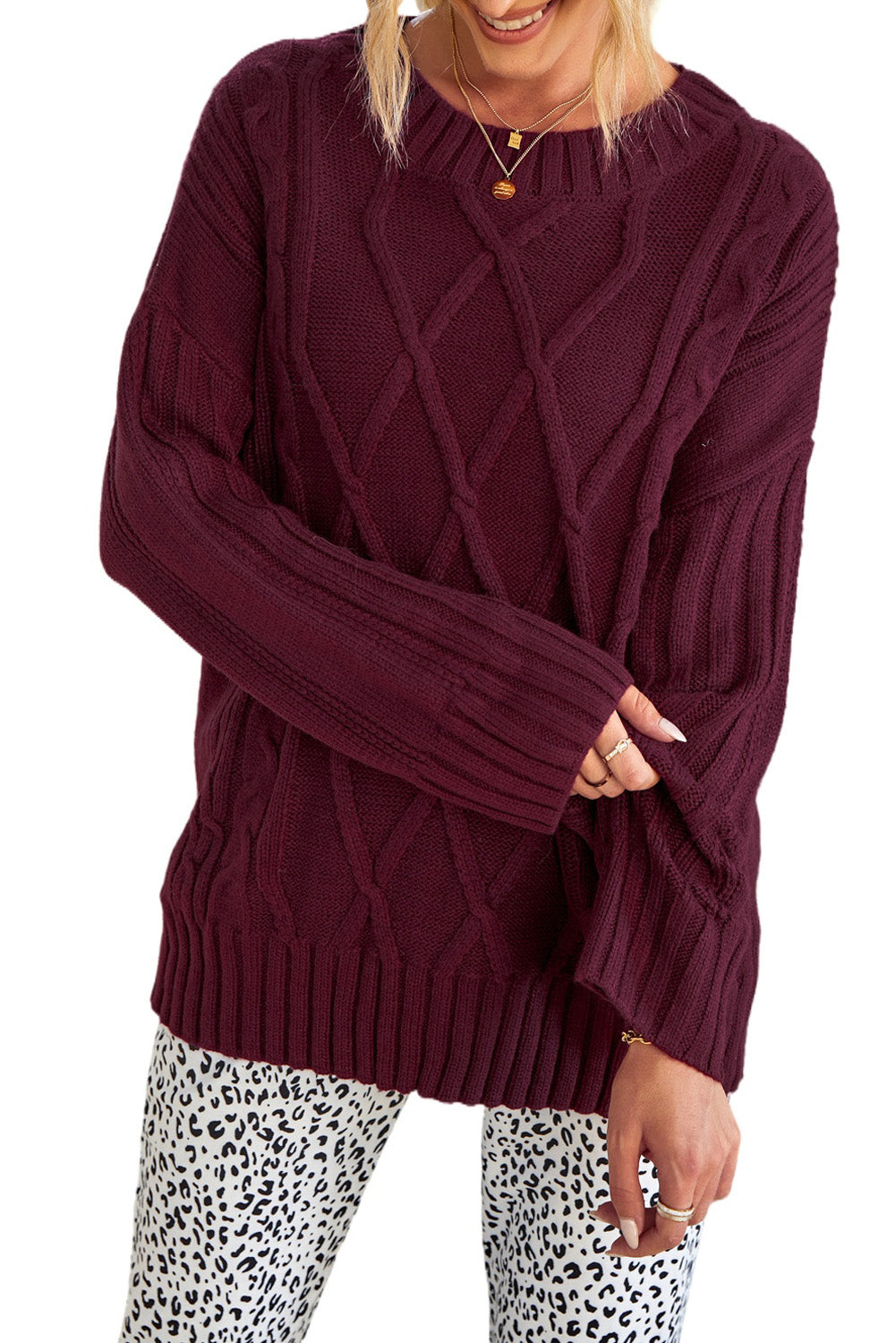 A cozy pink oversize thick pullover sweater with a cable knit design, perfect for winter wear.