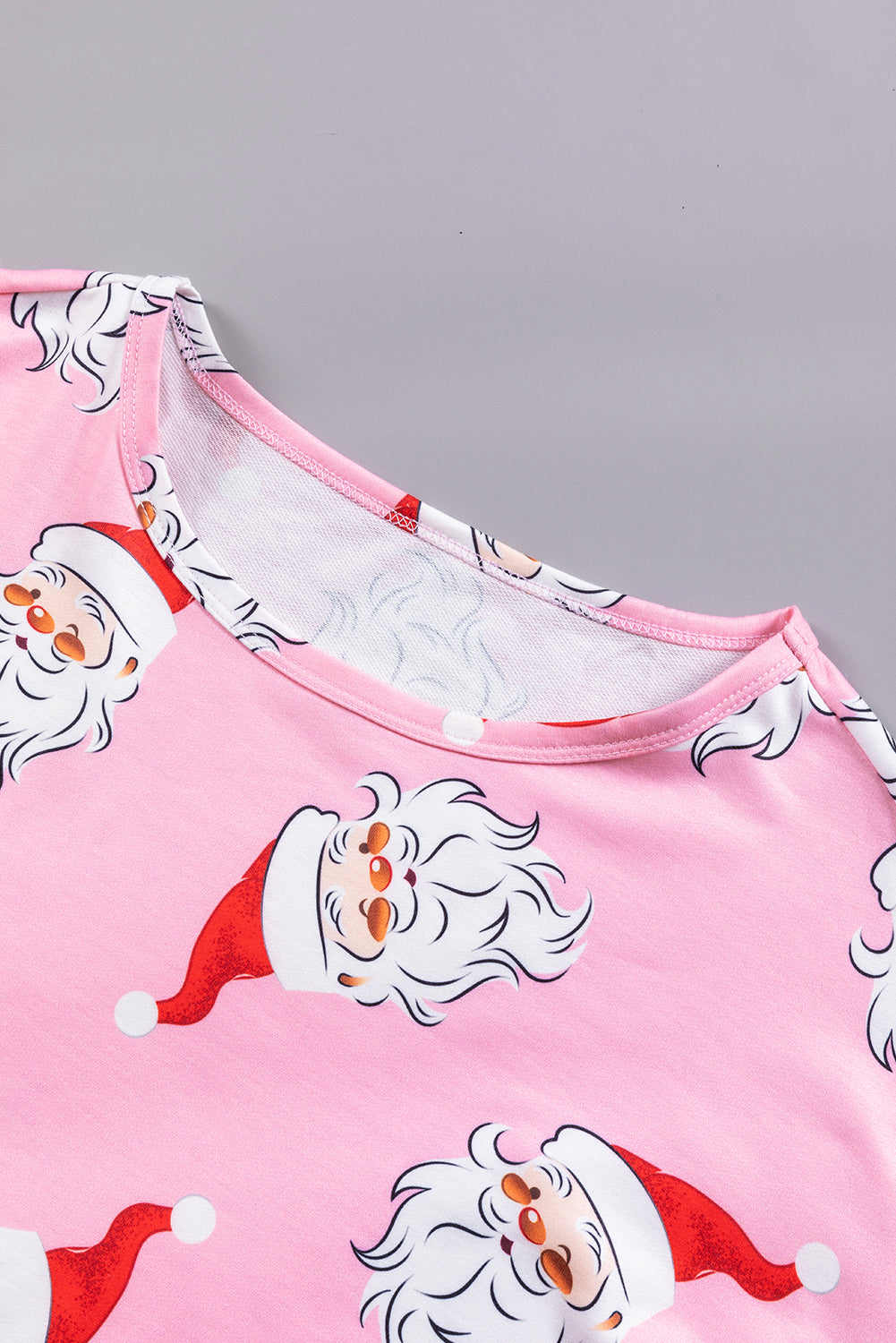 A stylish pink blouse featuring a festive Santa Claus print and elegant lantern sleeves, perfect for Christmas celebrations.