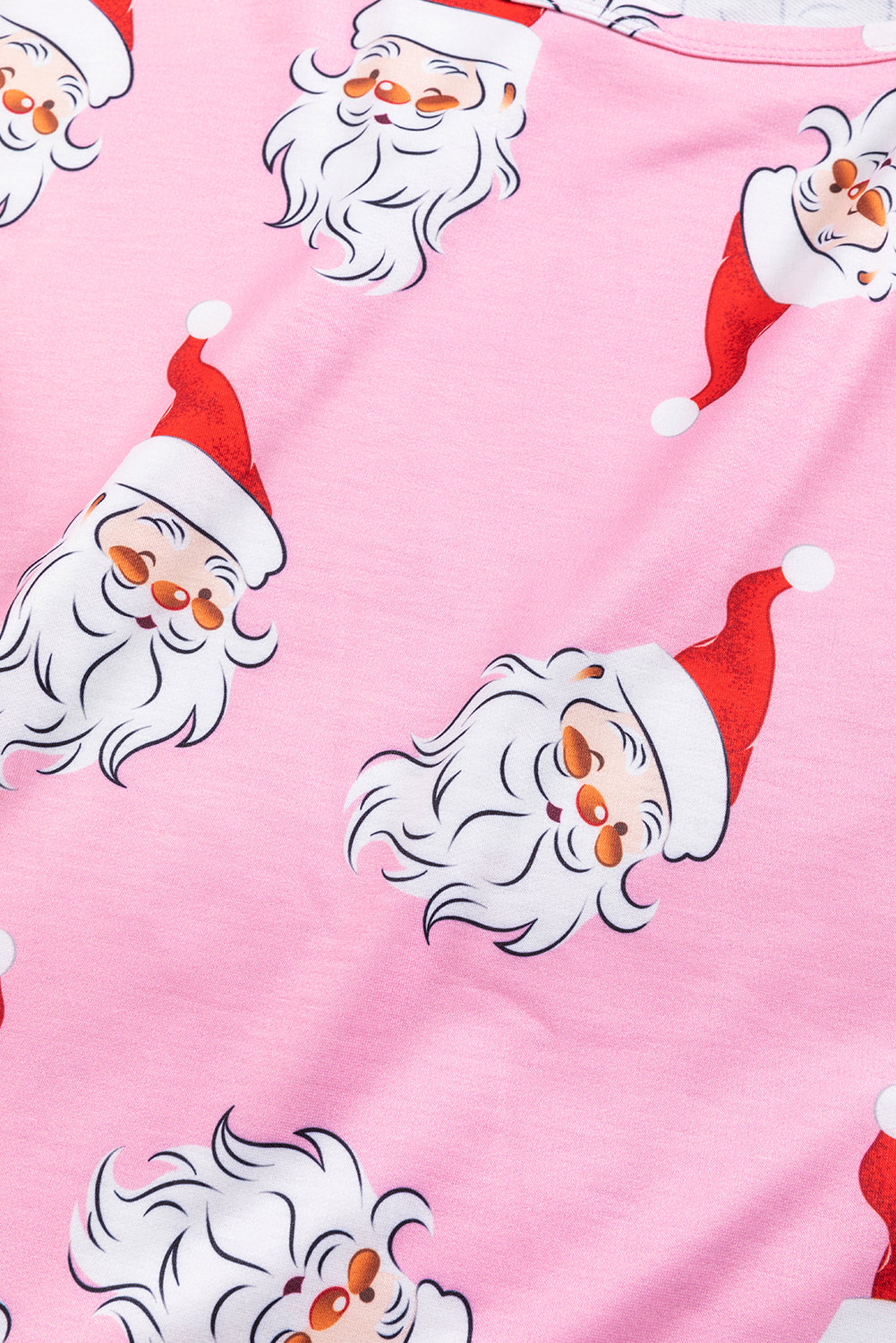 A stylish pink blouse featuring a festive Santa Claus print and elegant lantern sleeves, perfect for Christmas celebrations.