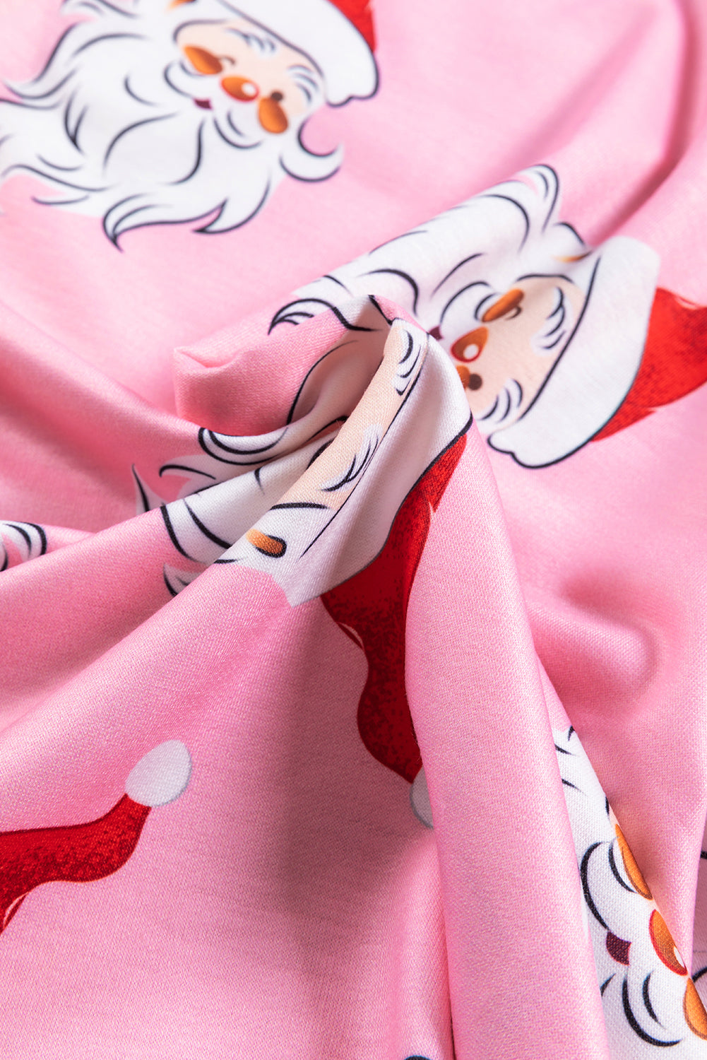 A stylish pink blouse featuring a festive Santa Claus print and elegant lantern sleeves, perfect for Christmas celebrations.