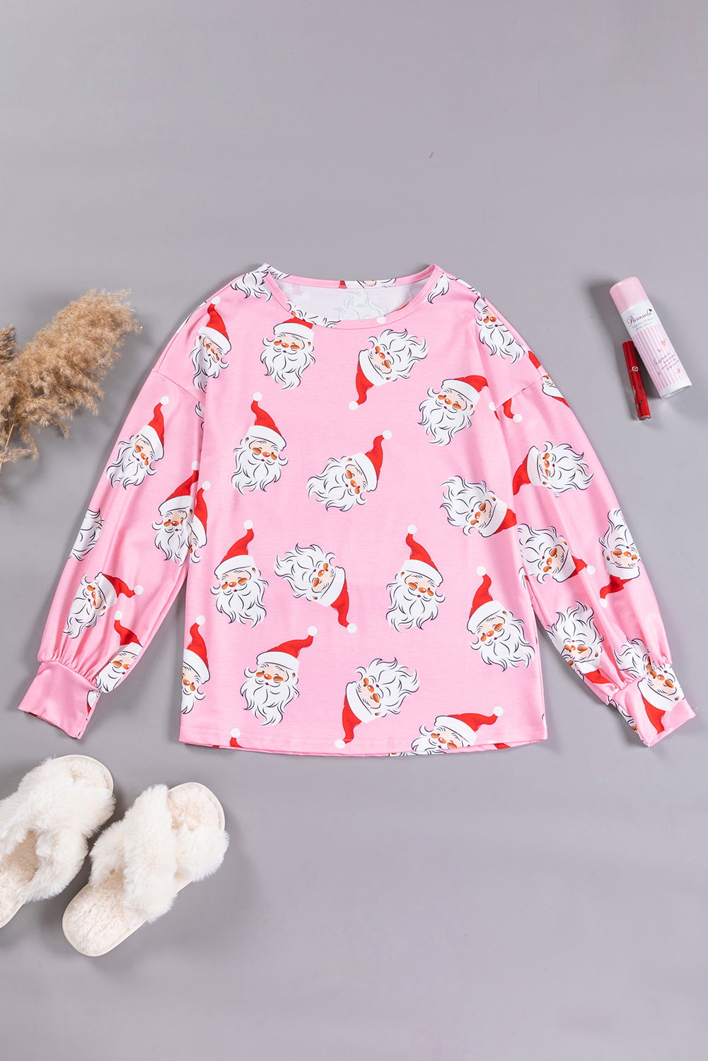 A stylish pink blouse featuring a festive Santa Claus print and elegant lantern sleeves, perfect for Christmas celebrations.