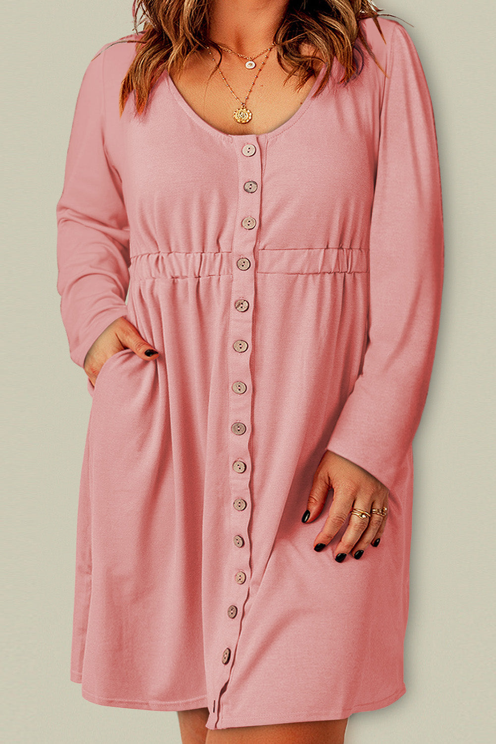 A stylish pink solid button front plus size long sleeve dress displayed on a mannequin, featuring a scoop neck and side pockets.