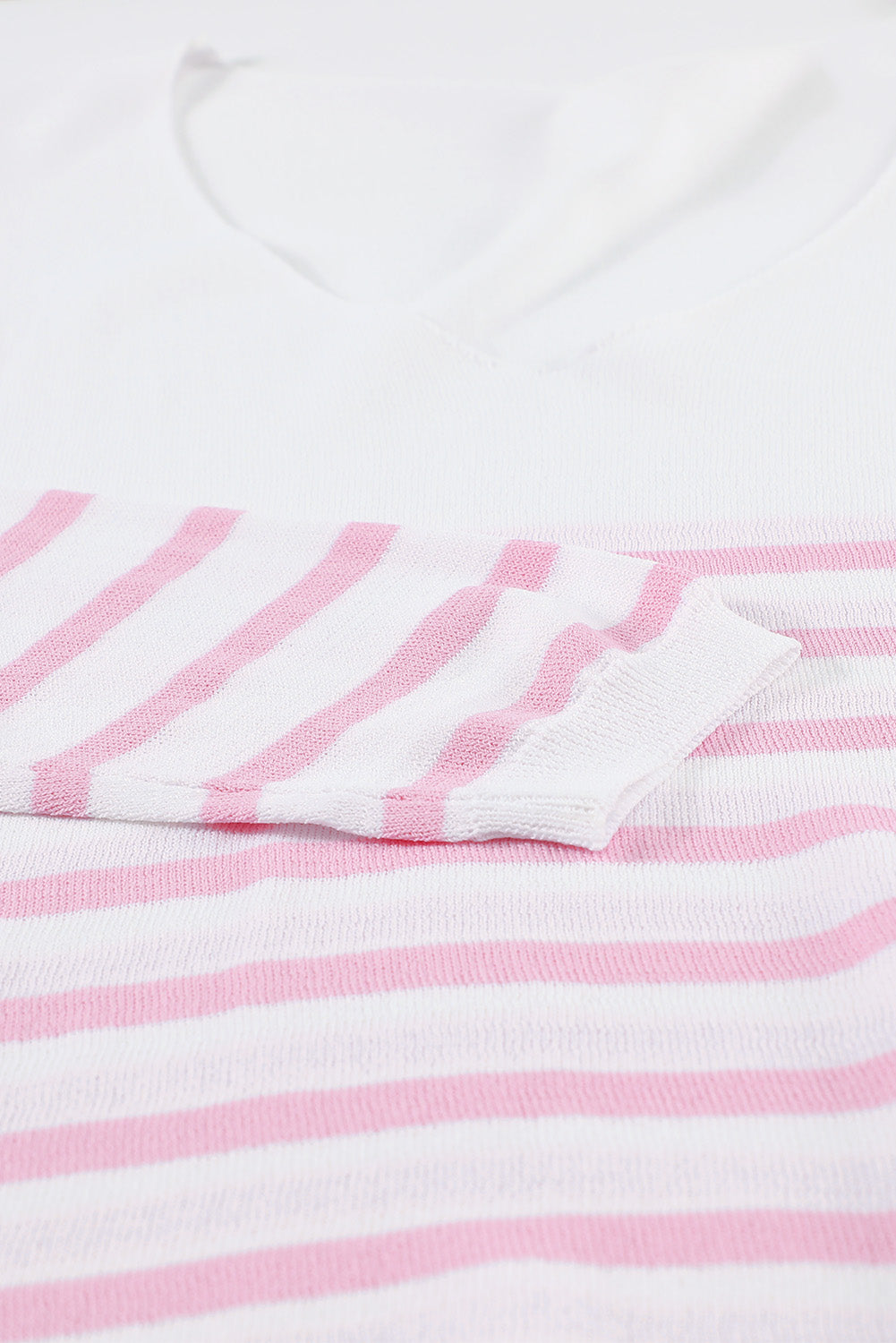 A stylish pink striped V neck long sleeve sweater displayed on a mannequin, showcasing its casual and chic design.