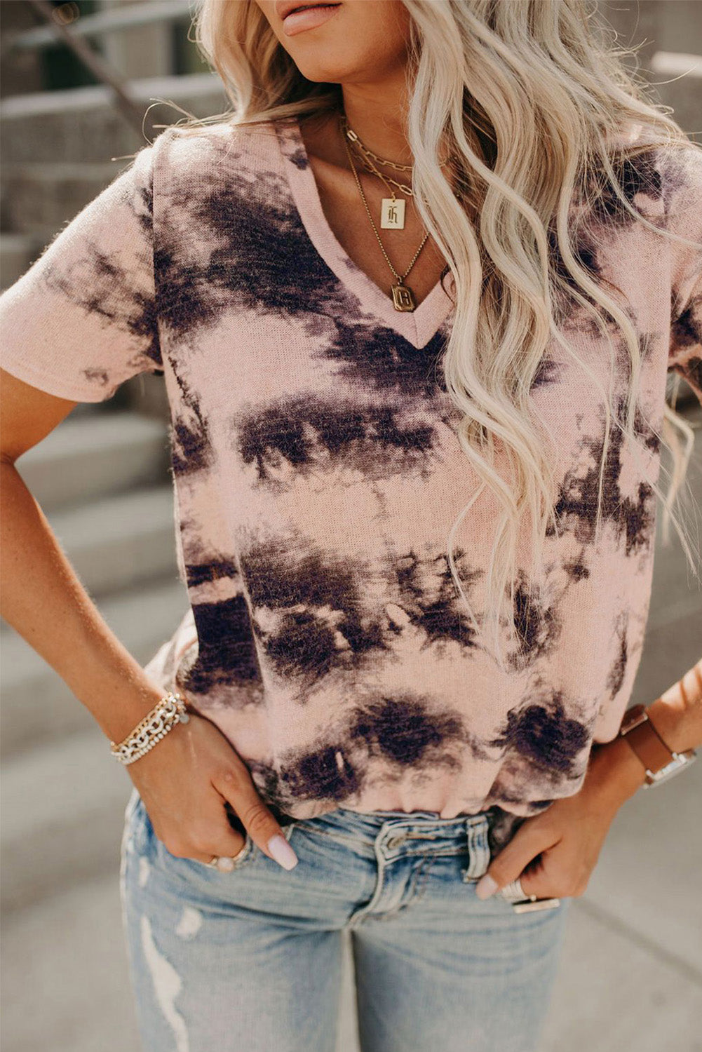 A stylish pink tie-dye V neck t-shirt for women, showcasing a vibrant and trendy design perfect for summer wear.