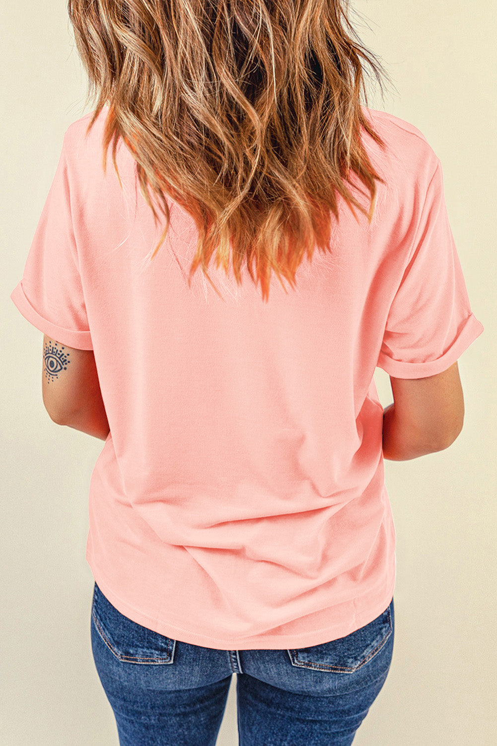 A stylish pink t-shirt featuring a cowboy boots print, perfect for casual wear, with a round neck and short sleeves.