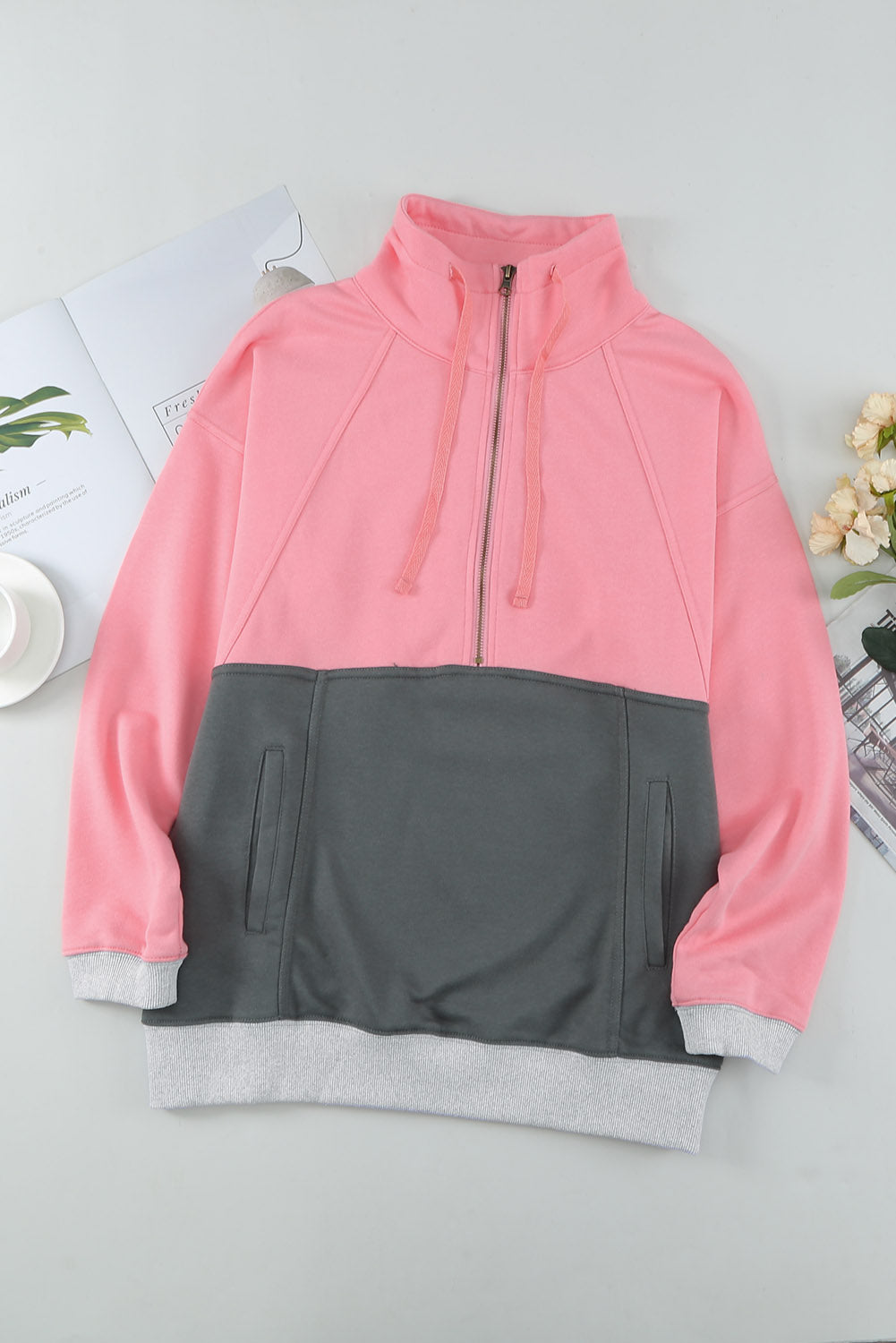 A stylish pink zipped colorblock sweatshirt with pockets, featuring a turn-down collar and a fashionable design, perfect for women.