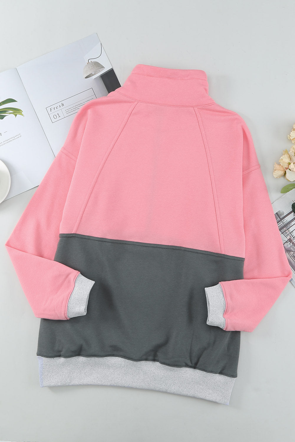 A stylish pink zipped colorblock sweatshirt with pockets, featuring a turn-down collar and a fashionable design, perfect for women.