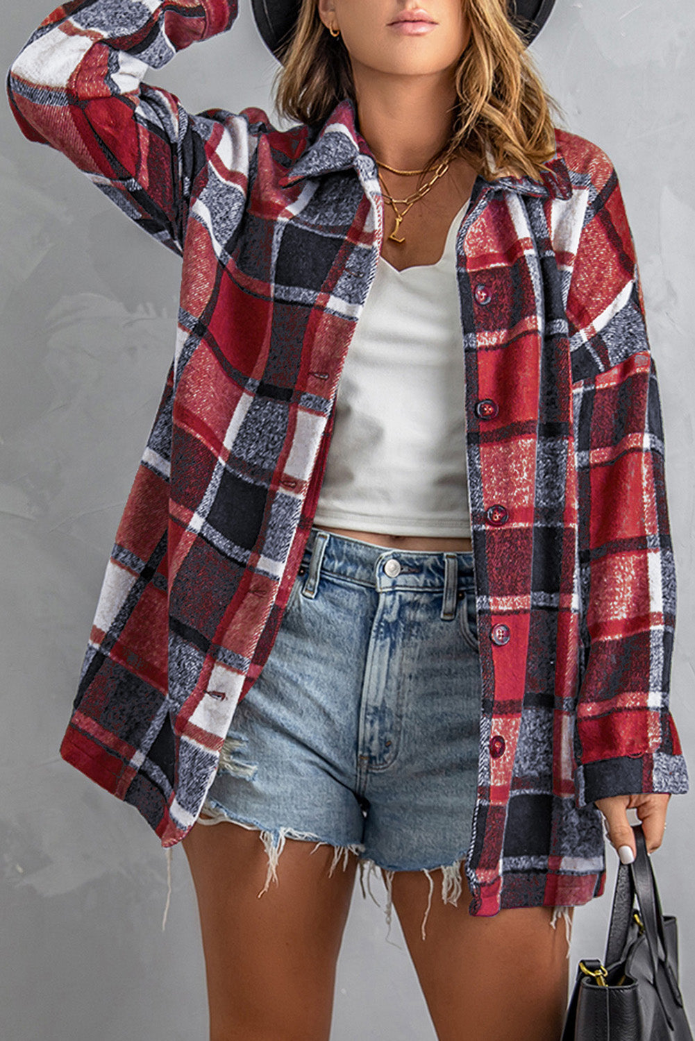 A stylish plaid print buttoned shirt jacket in warm tones, showcasing its soft fabric and button closure design.