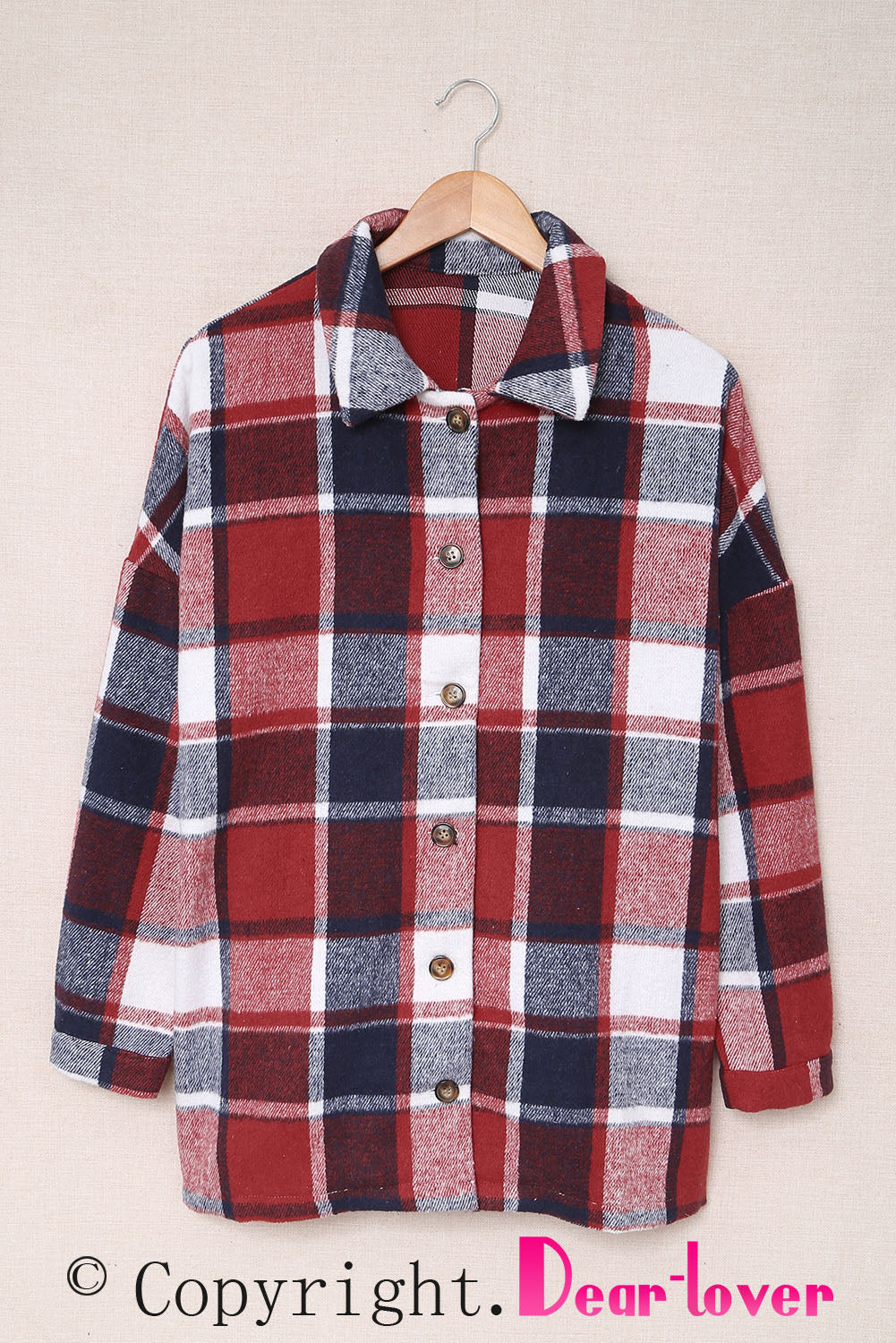 A stylish plaid print buttoned shirt jacket in warm tones, showcasing its soft fabric and button closure design.