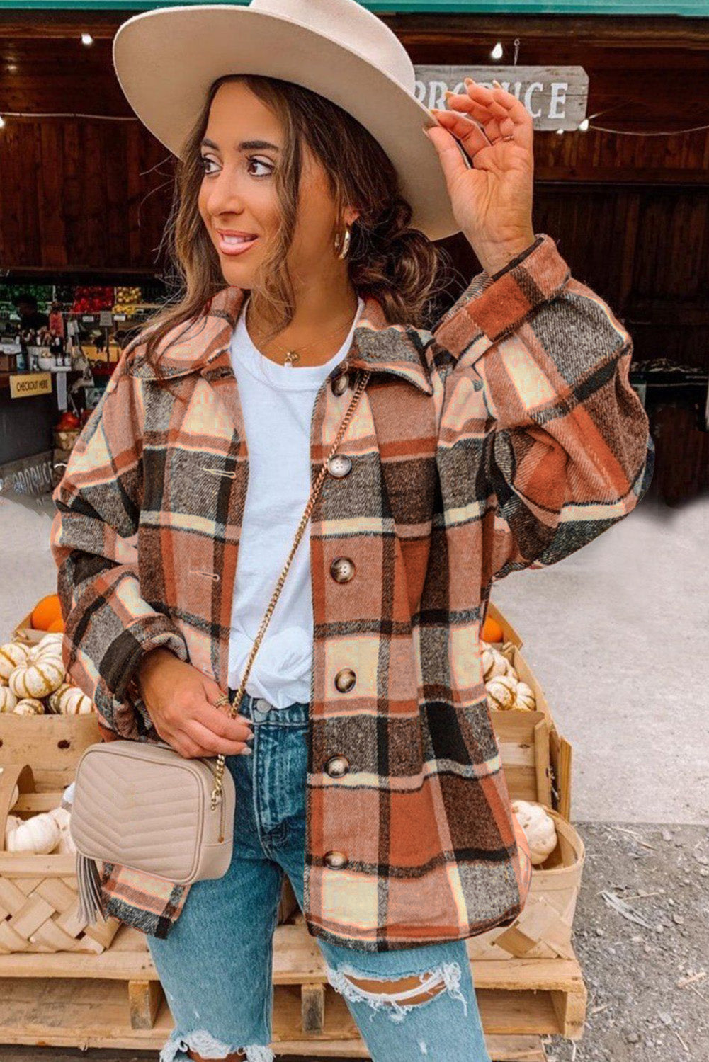 A stylish plaid print buttoned shirt jacket in warm tones, showcasing its soft fabric and button closure design.