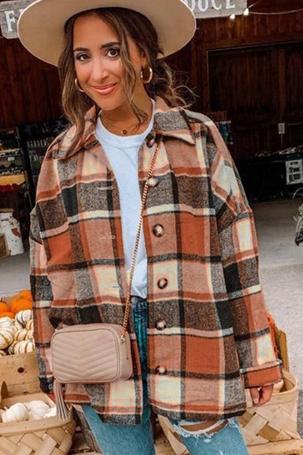 A stylish plaid print buttoned shirt jacket in warm tones, showcasing its soft fabric and button closure design.