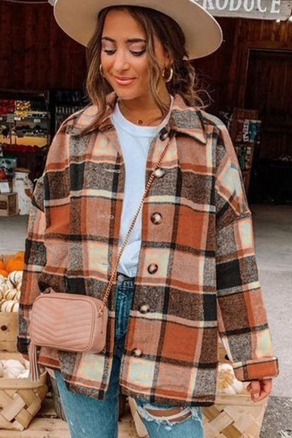 A stylish plaid print buttoned shirt jacket in warm tones, showcasing its soft fabric and button closure design.