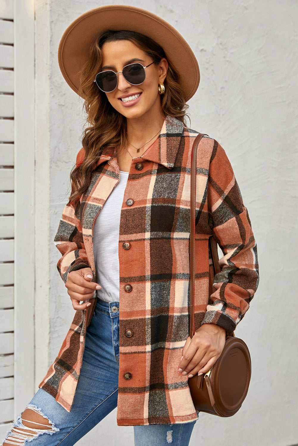 A stylish plaid print buttoned shirt jacket in warm tones, showcasing its soft fabric and button closure design.