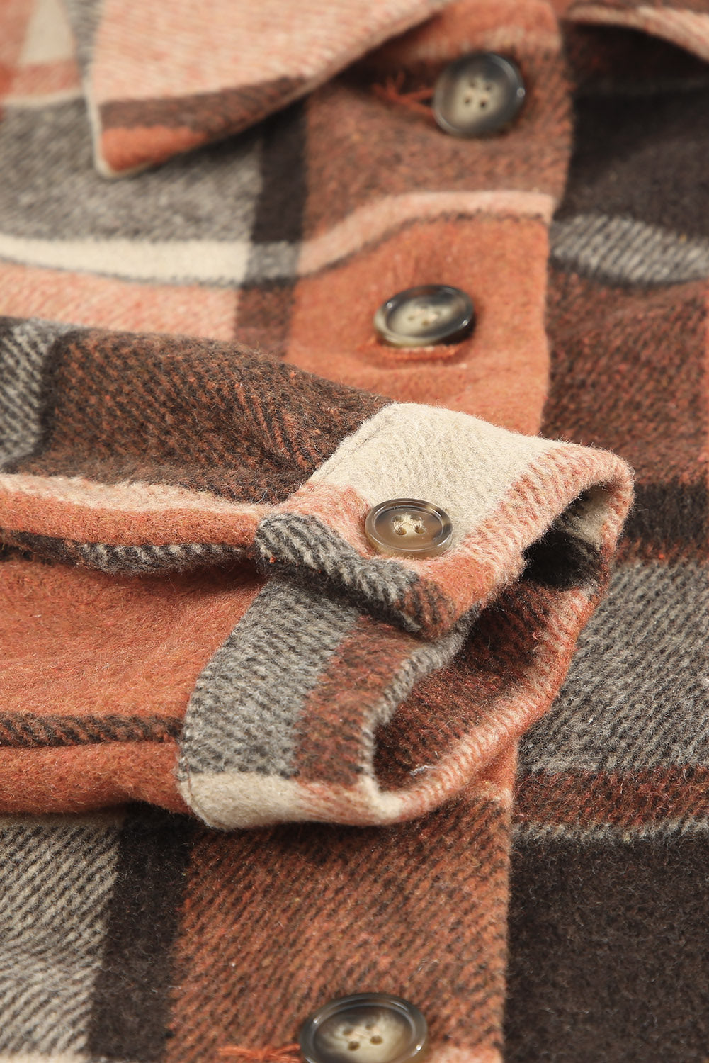 A stylish plaid print buttoned shirt jacket in warm tones, showcasing its soft fabric and button closure design.