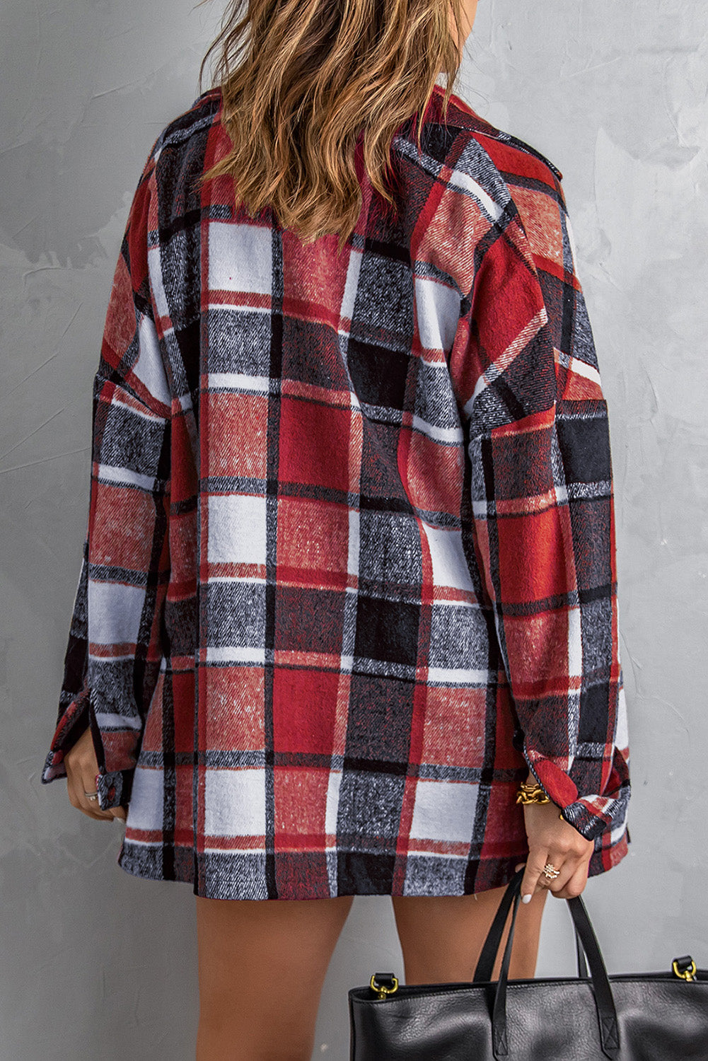 A stylish plaid print buttoned shirt jacket in warm tones, showcasing its soft fabric and button closure design.