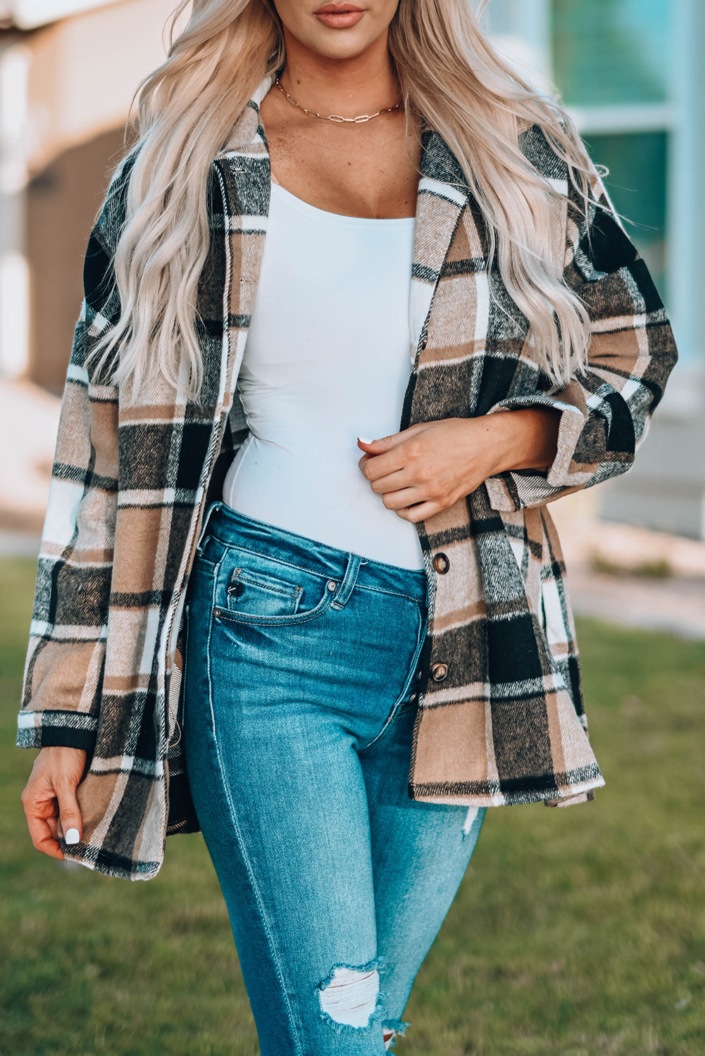 A stylish plaid print buttoned shirt jacket in warm tones, showcasing its soft fabric and button closure design.