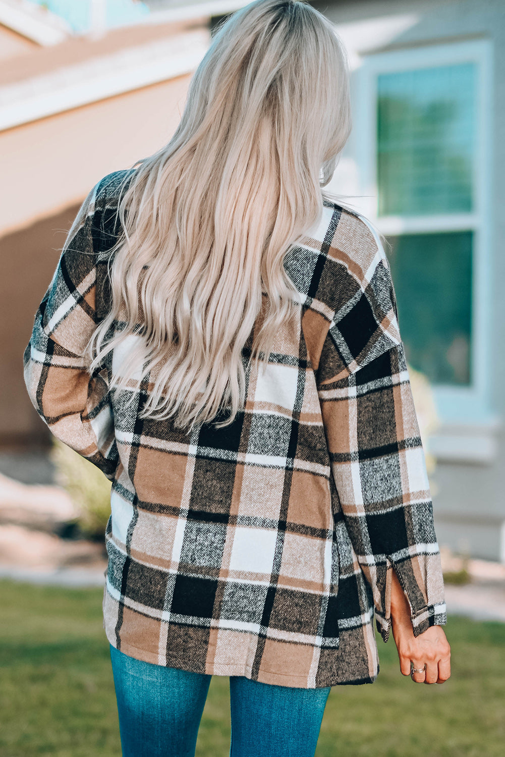 A stylish plaid print buttoned shirt jacket in warm tones, showcasing its soft fabric and button closure design.