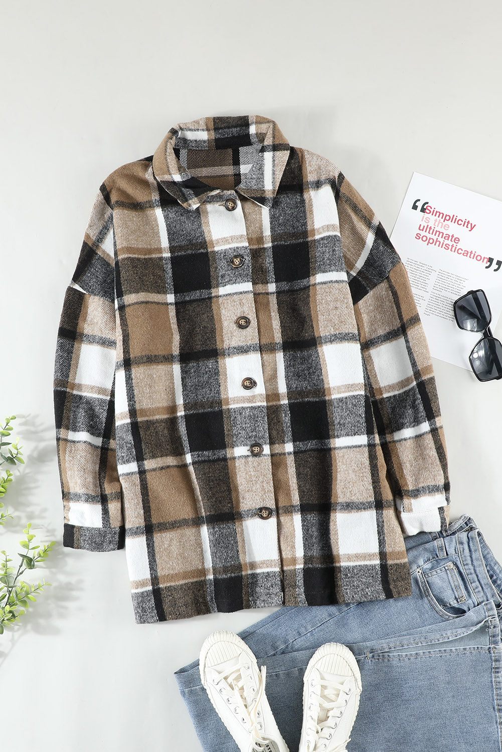 A stylish plaid print buttoned shirt jacket in warm tones, showcasing its soft fabric and button closure design.